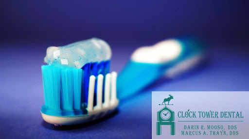 A blue and white toothbrush with sparkly blue toothpaste.